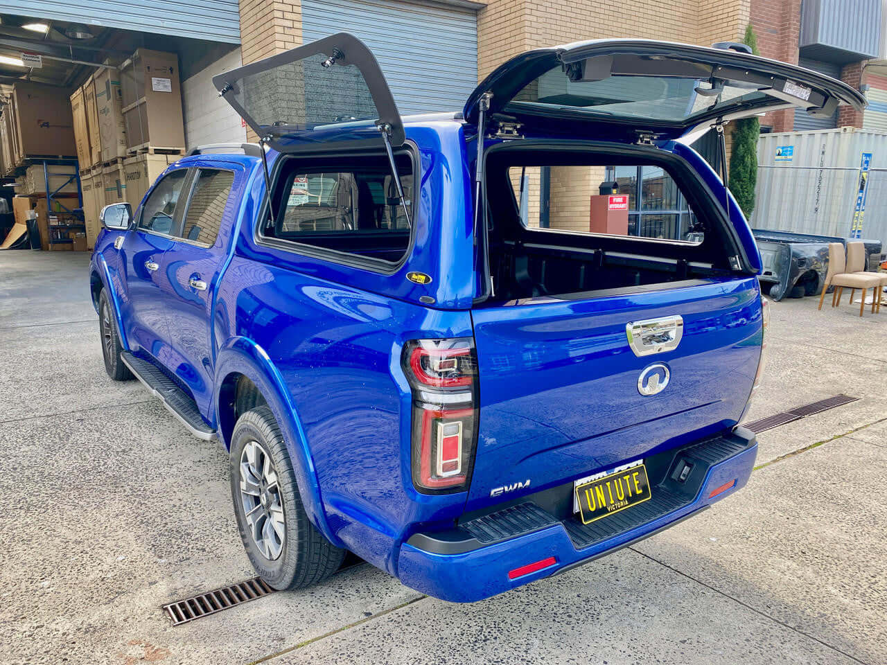 UniUte FORCE PRO gwm cannon canopy on blue GWM Cannon Ute 2020-2025, showcasing rear and side views with open canopy doors.