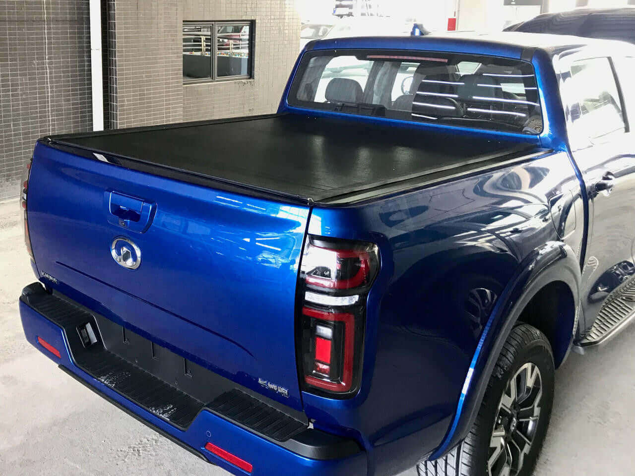 REVOLVER tonneau on GWM Cannon — partially rolled showing tub access