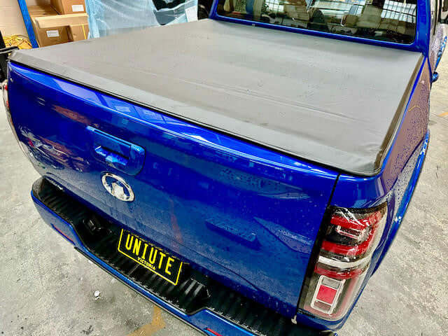 GWM Cannon Tonneau Cover 2020-2025 installed on a blue ute, showcasing the soft roll-up design for style and protection.