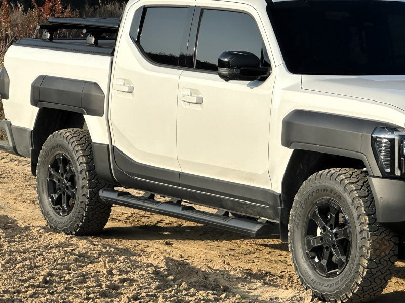 Black KIA Tasman side steps 2025+ for enhanced access, strength, and style on a rugged off-road vehicle.