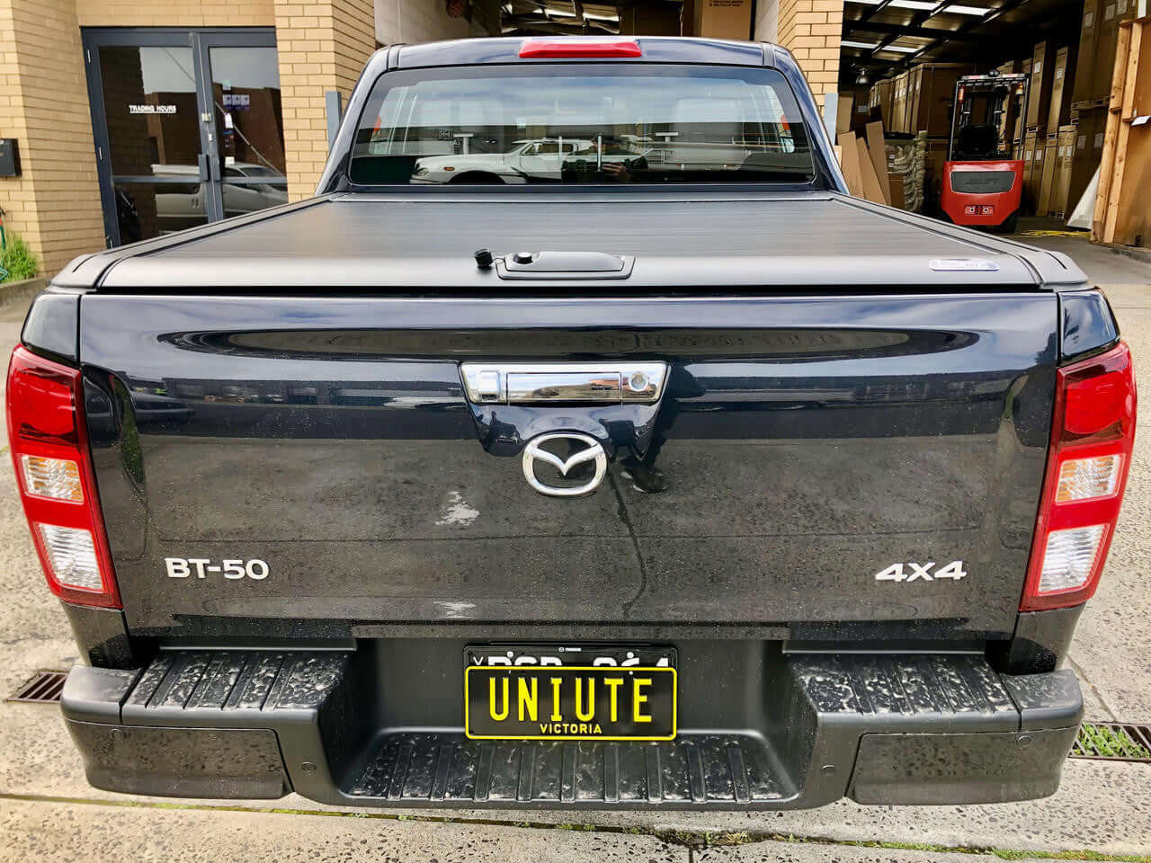 Isuzu D-Max 2021-2026 with UniUte electric roller shutter — side view closed