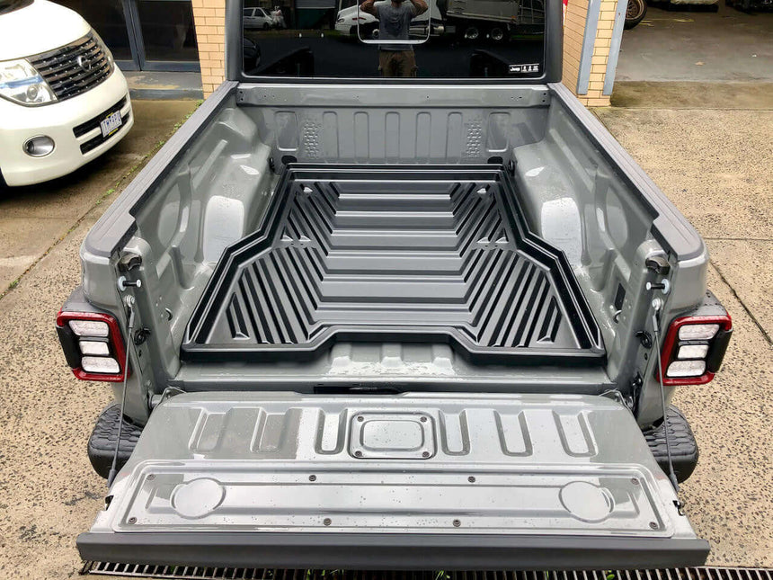 Cargo tray in Jeep Gladiator 2020-2025 with sliding tray drawer for enhanced storage.