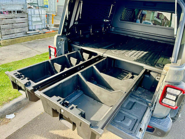 Jeep Gladiator ute drawers 2020-2025 shown open, highlighting the weathertight storage system for tools and gear.