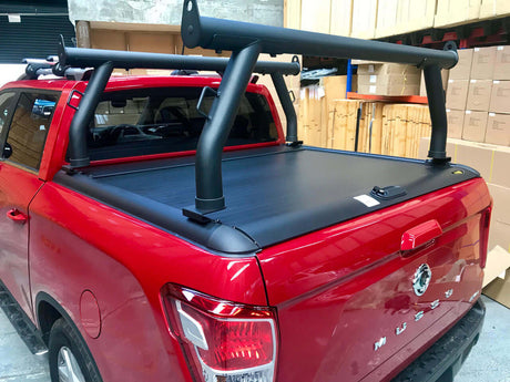 Red ute equipped with ladder racks for roller shutters Gen1 & Gen2, showcasing ultimate rear ladder rack for safe transportation.