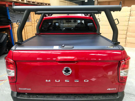 Red ute with ladder racks for Gen1 & Gen2 roller shutters, shown in a garage, emphasizing secure transportation of long items.