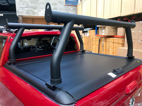 Ladder racks for Gen1 & Gen2 roller shutters installed on a red ute, offering secure transport for ladders and long items.