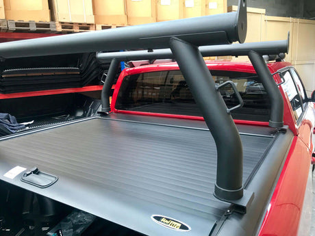 Ladder racks for Gen1 & Gen2 roller shutters on ute, showing secure attachment for transporting ladders and long items.