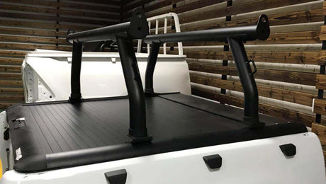 Ladder racks installed on a white ute with Gen1 & Gen2 roller shutters, ideal for safely carrying long items.