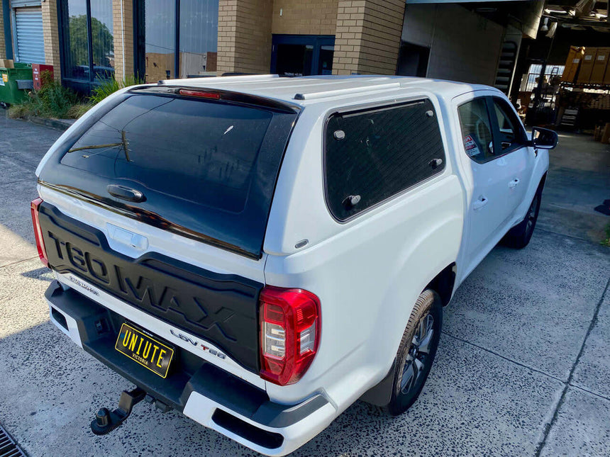 LDV T60 canopy 2017-2025 by UniUte FORCE PRO in white, providing ultimate protection and style, parked outside a building.