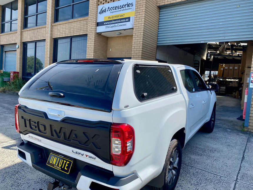 White truck with UniUte FORCE PRO ldv t60 canopy parked outside accessories store.