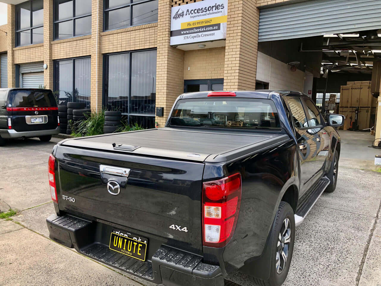 Mazda BT-50 with UniUte EGen2 Electric mazda bt50 roller shutter installed at an accessory shop.