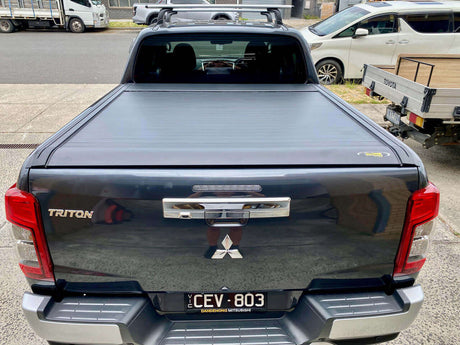 Black Triton roller lid installed on Mitsubishi Triton MQ & MR, showcasing UniUte EGen2 Electric Roller Shutter, rear view.