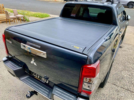 Mitsubishi Triton MQ MR with UniUte EGen2 Electric Black Roller Shutter, showcasing the sleek triton roller lid, parked in driveway