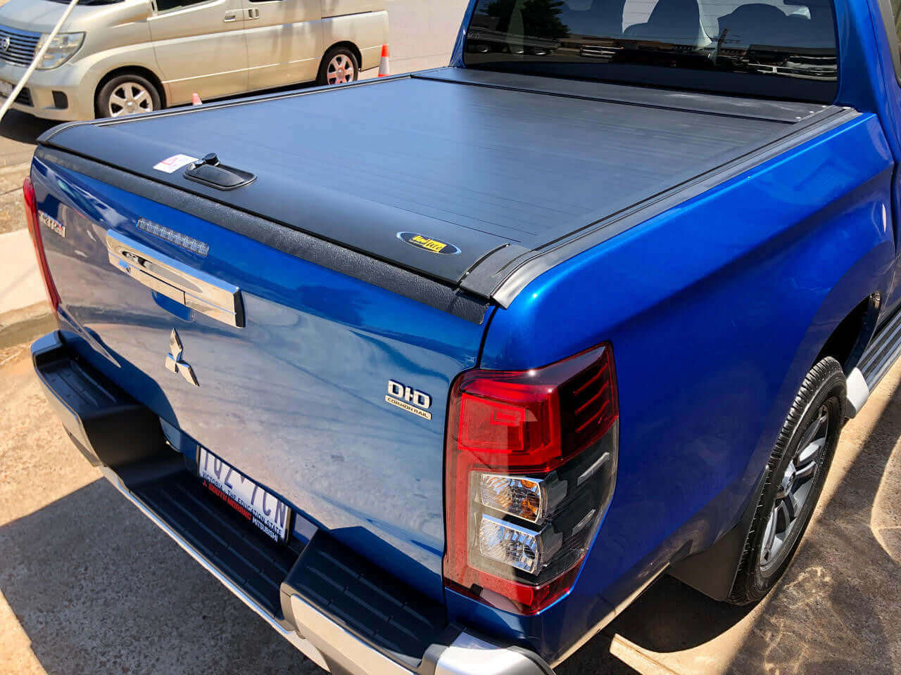 Blue Mitsubishi Triton with UniUte Gen2 Manual triton roller shutter for 2015-2024 models, showing sleek design.