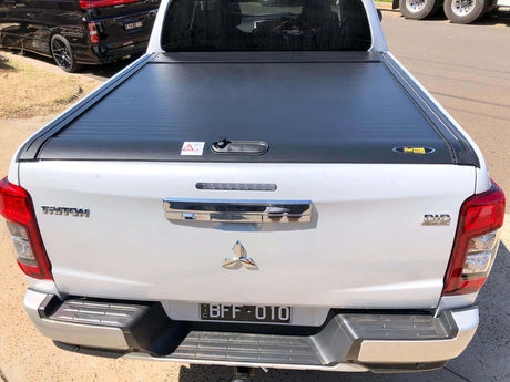 Triton roller shutter on a Mitsubishi MQ & MR truck bed, 2015-2024 Gen2 manual cover for secure and stylish utility.