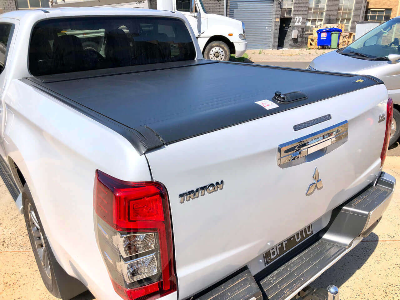 Triton roller shutter on a Mitsubishi Triton MQ truck, enhancing utility and protection, 2015-2024 model in urban setting