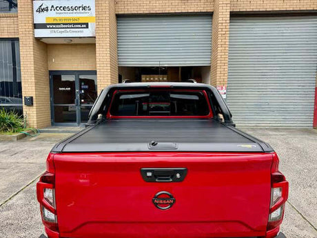 UniUte Gen2 manual roller shutter for Nissan Navara NP300 demonstrating cargo protection on a red truck.