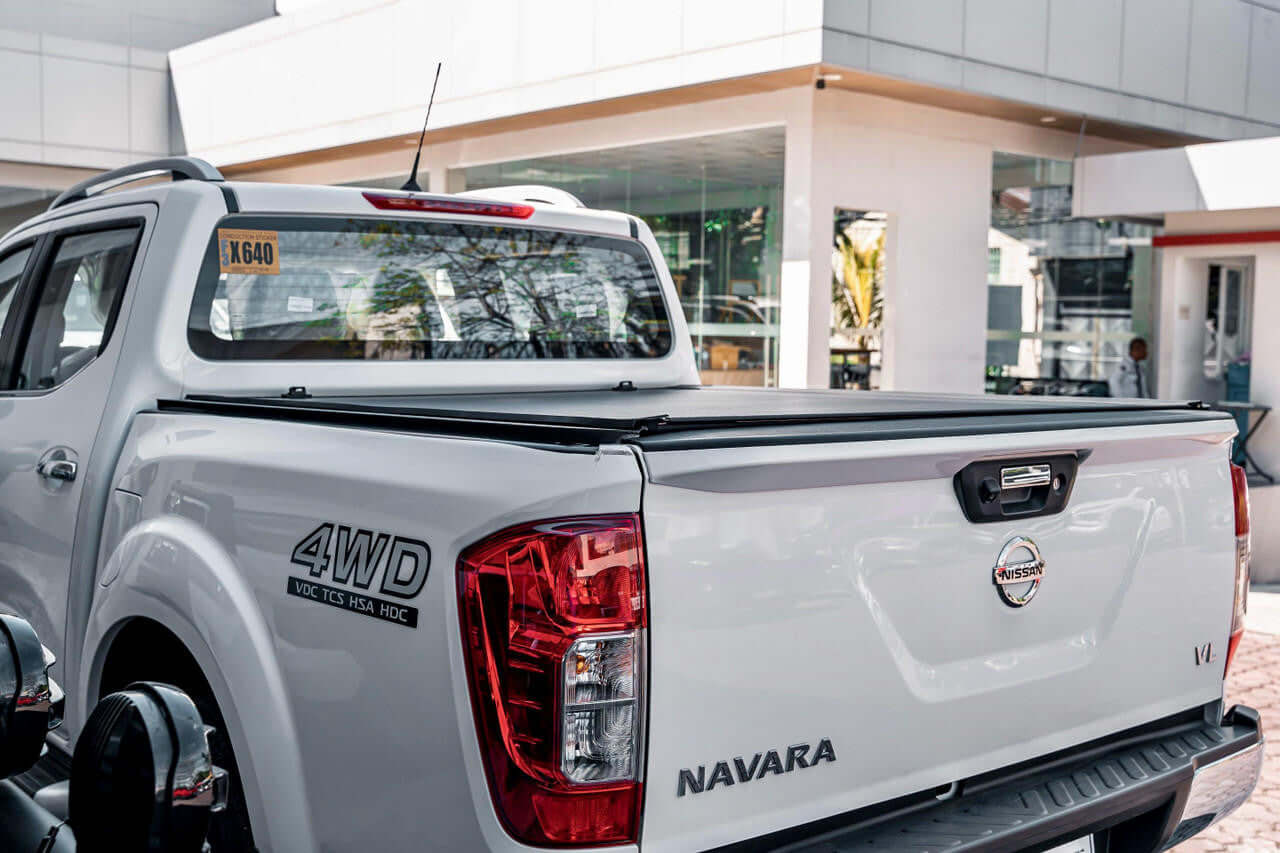 Navara NP300 REVOLVER cover — half-open showing cargo access