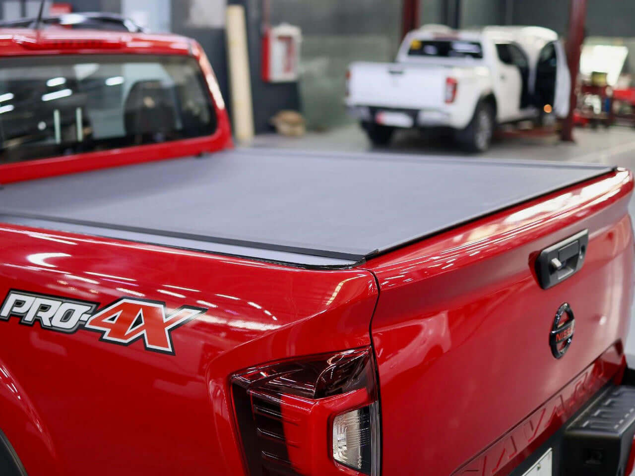 Nissan Navara NP300 2021-2025 with REVOLVER cover — rear view showing slat detail