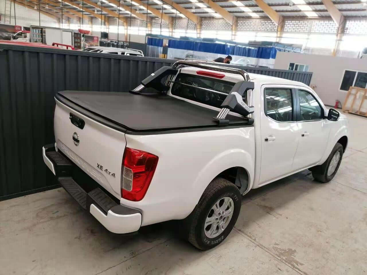 nissan navara cover tonneau soft roll up installed on white pickup truck