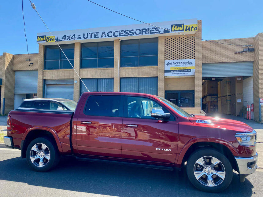 Red RAM 1500 with ram 1500 roller cover parked at UniUte store