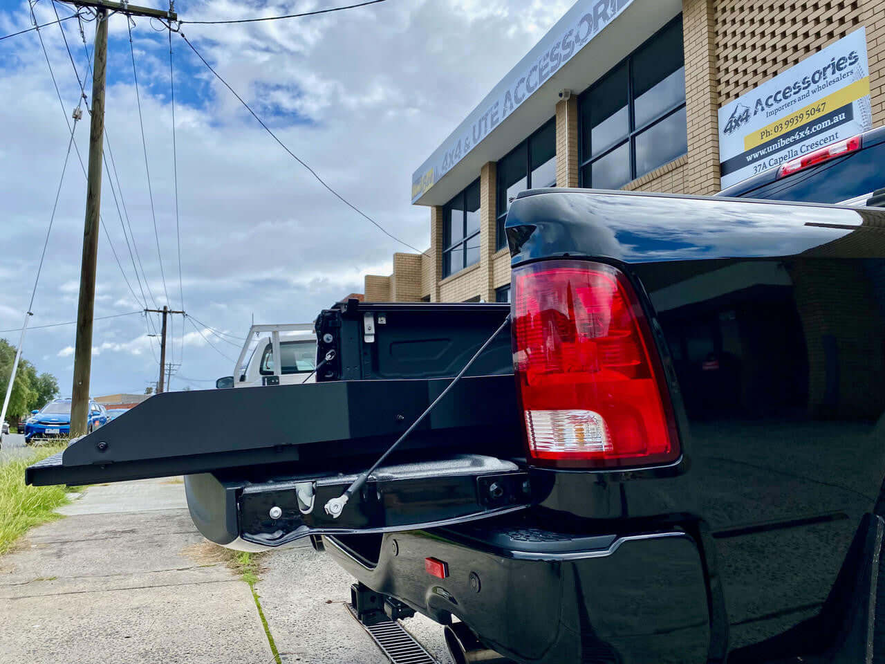 RAM 1500 with ute sliding tray fully extended outside accessory store