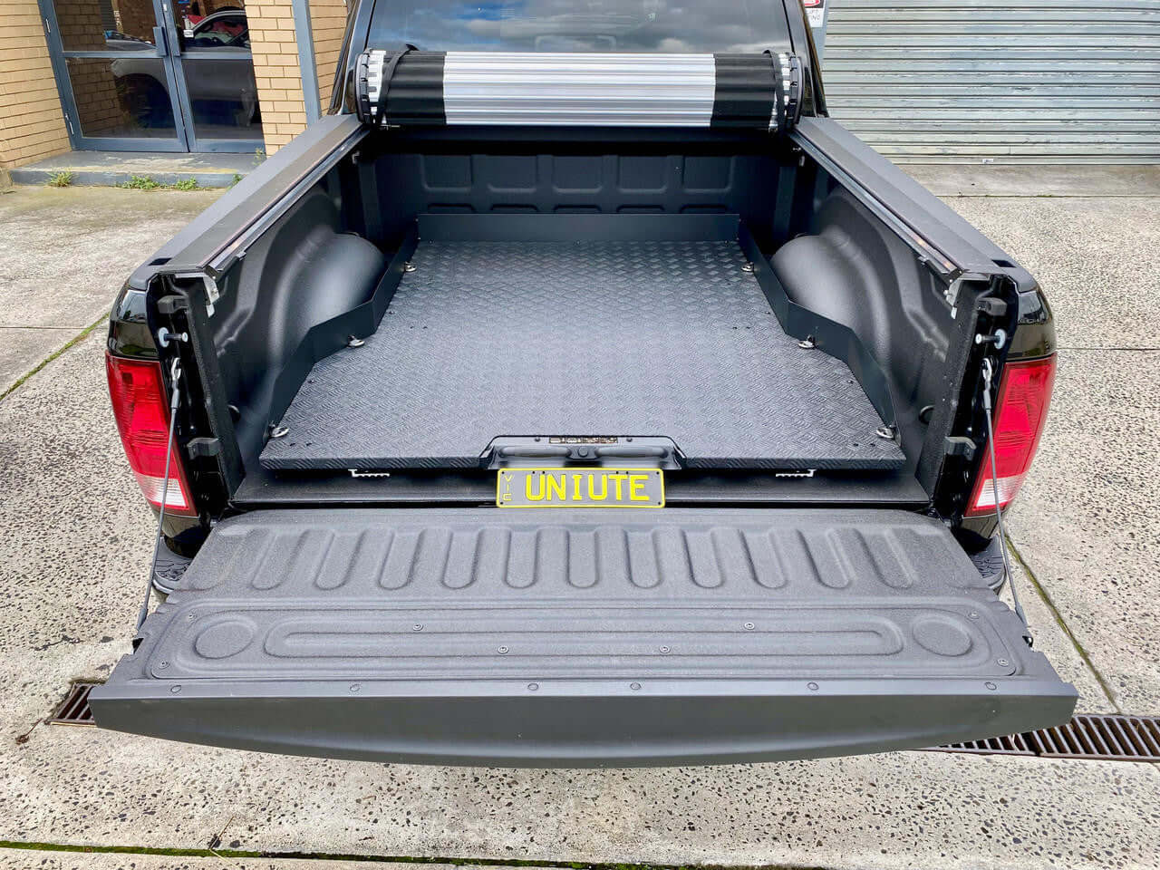 Ute sliding tray installed in RAM 1500 5'7" bed, showcasing cargo utility and convenience.