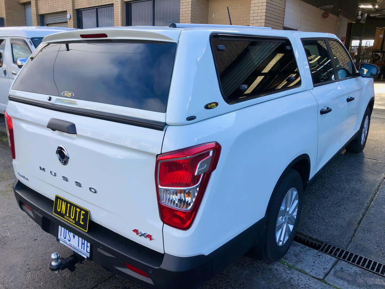White SsangYong Musso XLV with FORCE PRO canopy for ssangyong musso, rear view