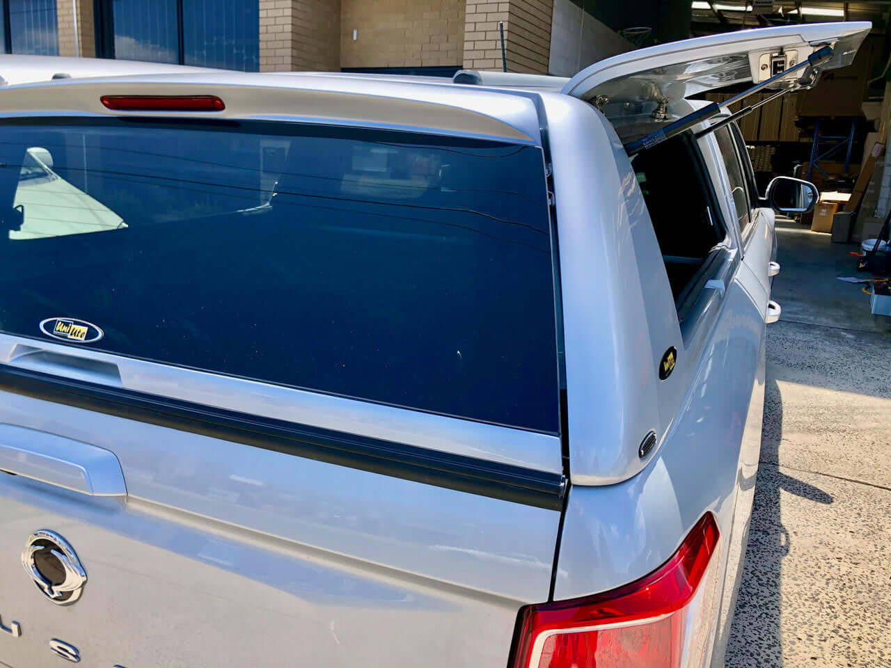 Rear view of SsangYong Musso XLV Canopy FORCE PRO PLUS with open hatch, showcasing advanced design for 2018-2025 models