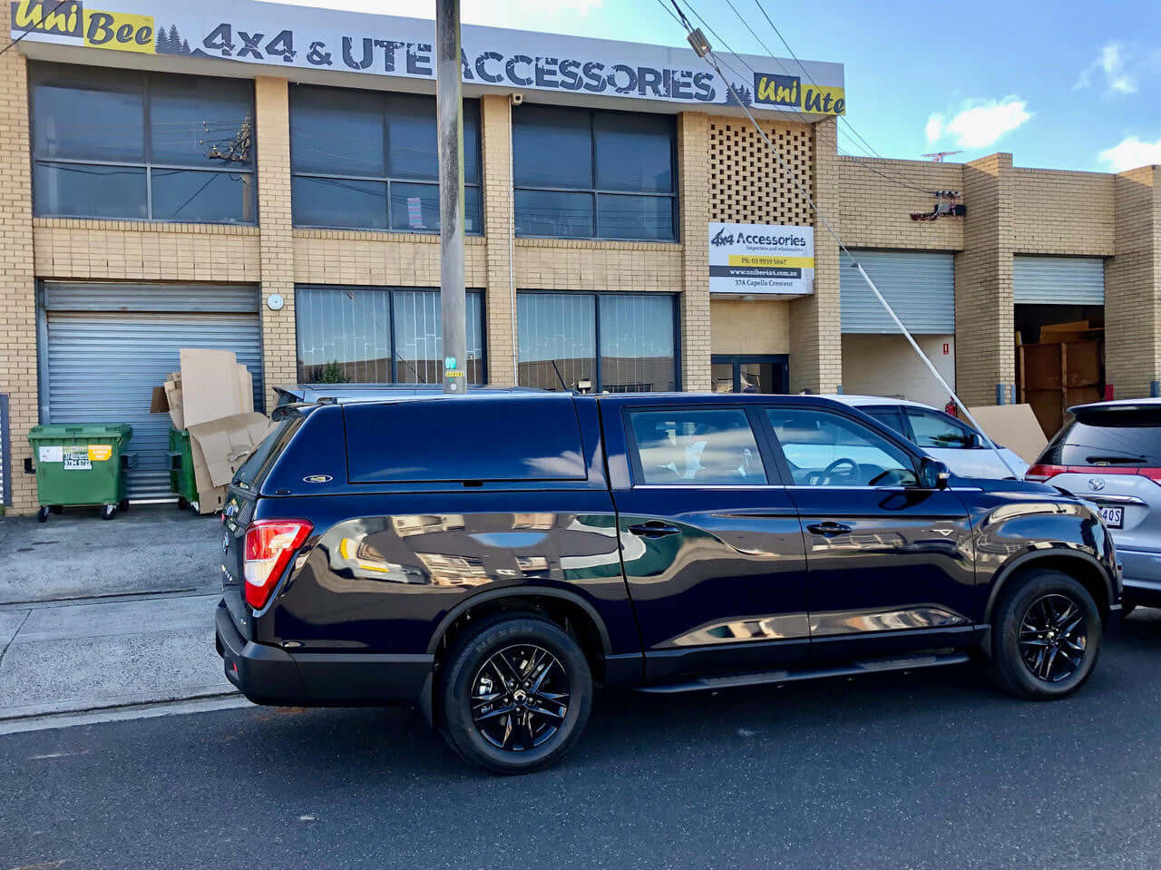 SsangYong Musso XLV Canopy FORCE PRO PLUS parked in front of UniUte 4x4 & UTE Accessories shop.