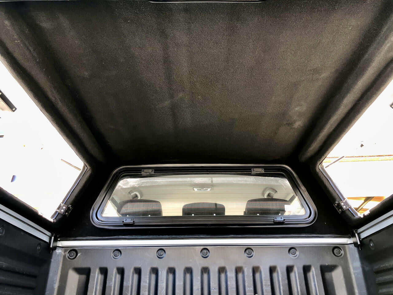 Interior view of SsangYong Musso XLV Canopy FORCCE PRO PLUS with detailed window and seat view, enhancing utility and style.