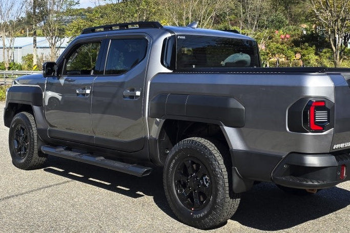 Grey truck featuring KIA Tasman Side Steps 2025+ Black Side Bars for enhanced access and protection.