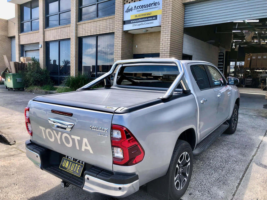 Toyota Hilux SR5 equipped with UniUte EGen2 electric hilux roller shutter at a 4x4 accessories shop.