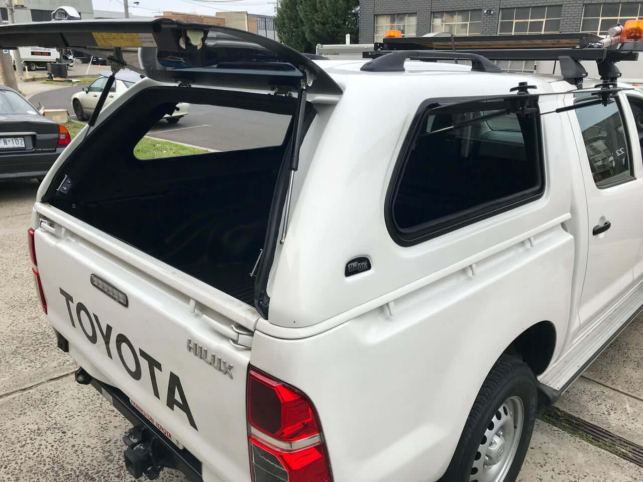 UniUte ELEGANCE Canopy for Toyota Hilux SR Workmate 2005-2014, showcasing rear view and open canopy for added utility.