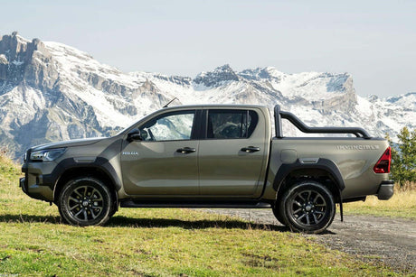 Truck with extended sports bar for Gen2/EGen2 roller shutters in scenic mountain landscape.