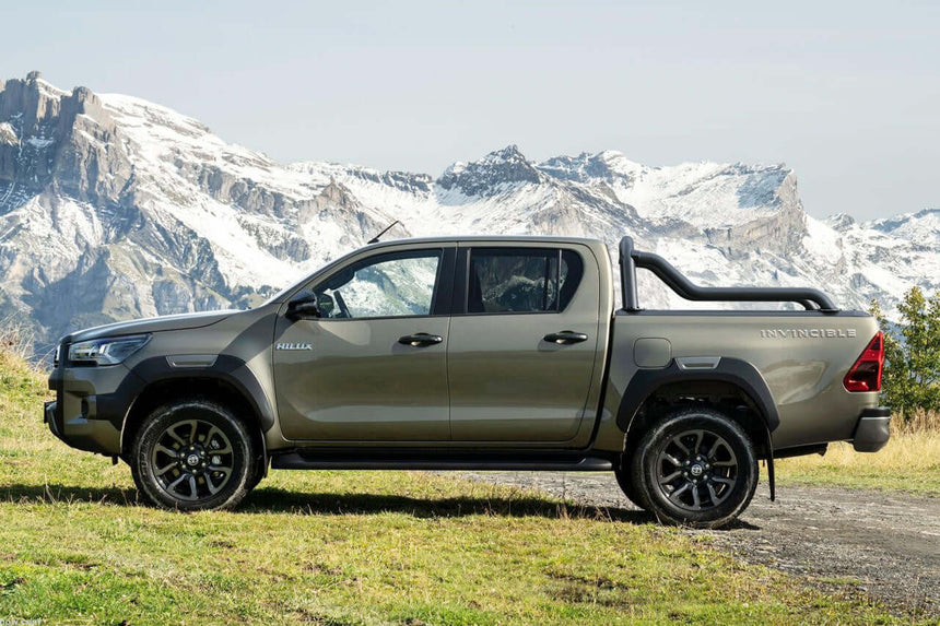 Truck with extended sports bar for Gen2/EGen2 roller shutters in scenic mountain landscape.