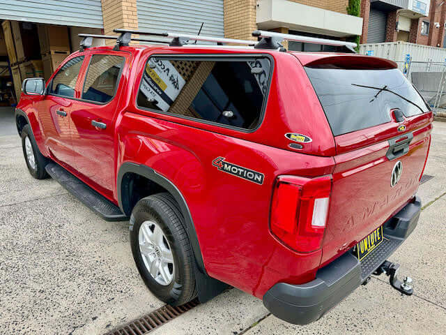 Red Volkswagen Amarok canopy 2023-2025 by UniUte, showcasing amarok canopy in parking area.