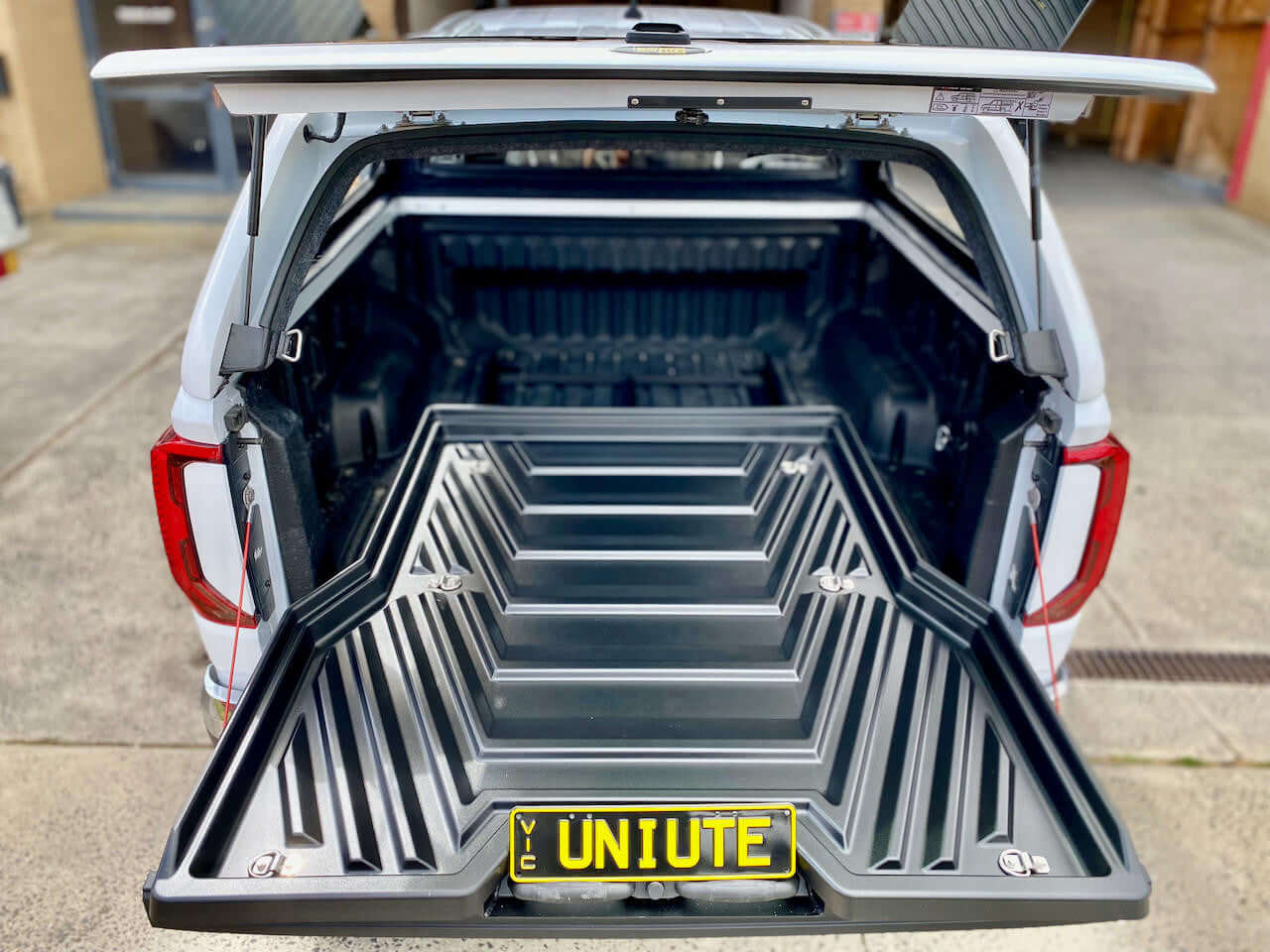 Ute slide out tray installed in Volkswagen Amarok 2023 model, showcasing the UniUte versatile sliding tray drawer in open position.