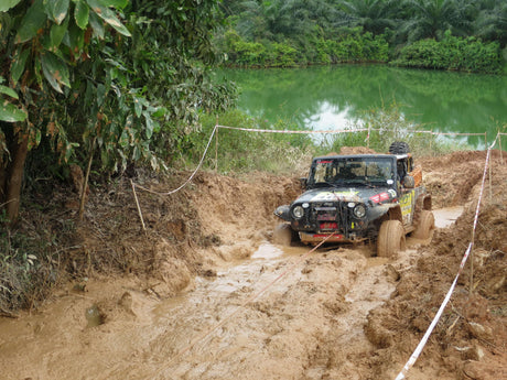 4x4 vehicle using Recovery Winches for Utes in muddy terrain near a lake