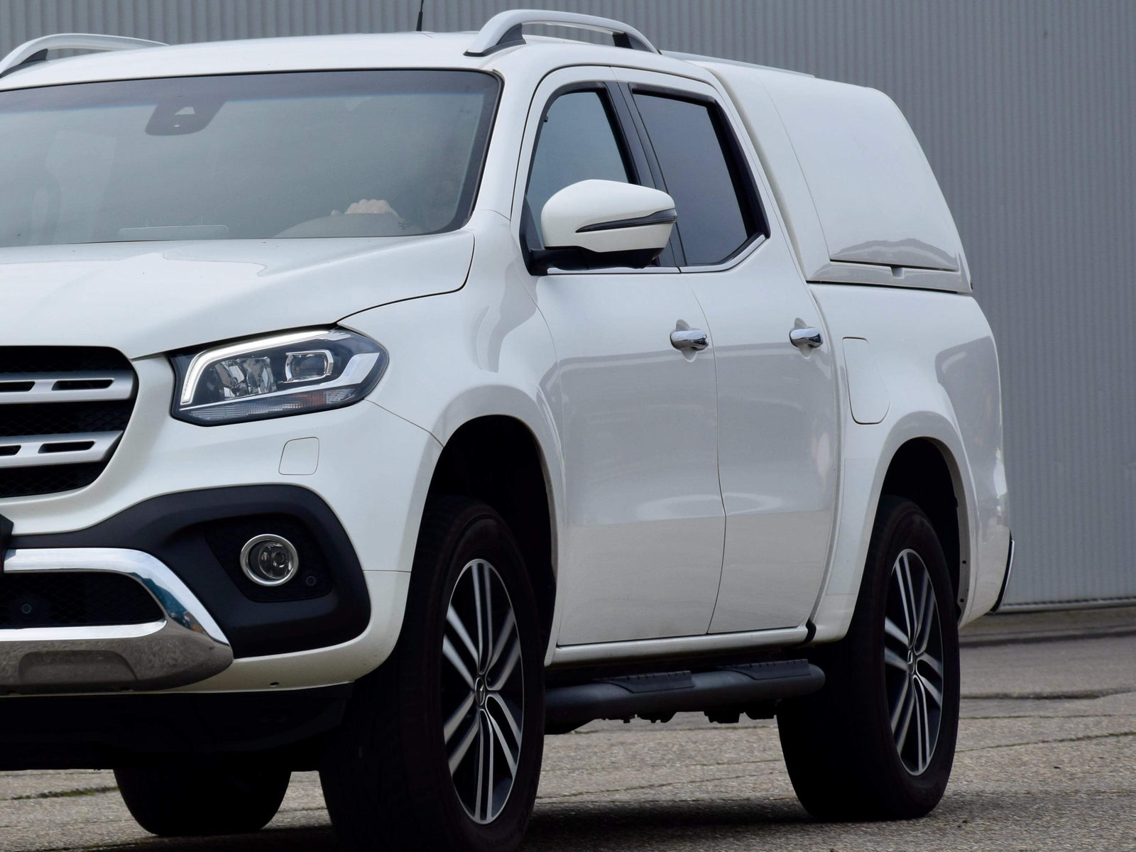 White 4x4 vehicle with WA Canopy in outdoor setting