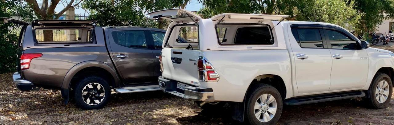 Two 4x4 vehicles equipped with UniUte Canopies shown in an outdoor setting, highlighting the practicality and stylish design of UniUte Canopies.