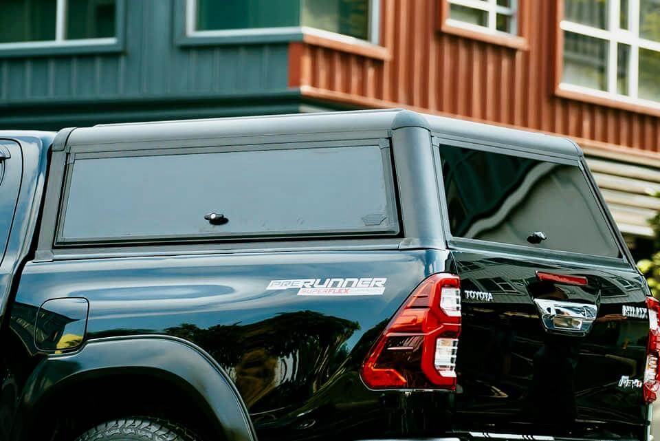 Black canopy for Ute on parked vehicle, showcasing durable design and sleek look.