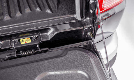 Close-up of Volkswagen Amarok tailgate strut for enhanced vehicle functionality and support.