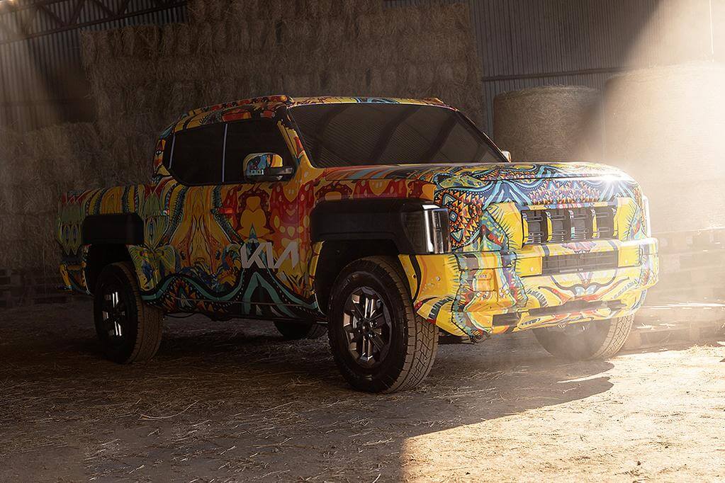 Kia Tasman Ute parked in warehouse with colorful design, showcasing its innovative 4x4 features.