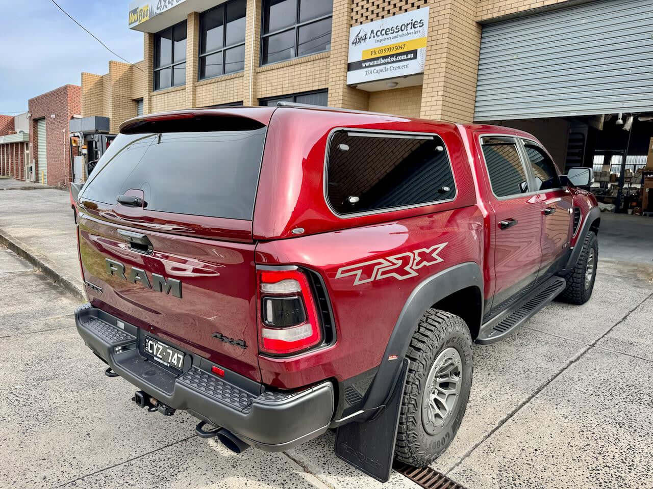 Dodge Ram accessories for enhanced performance and comfort parked in front of a building.