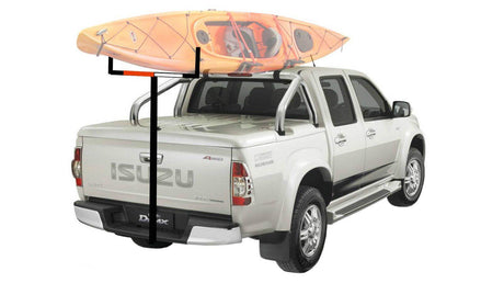 Pickup truck with roof rack kayak carriers transporting a kayak securely on top.
