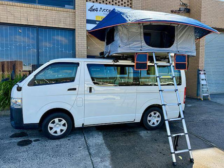 King Roof Top Tent setup on a white van with ladder access, showcasing an elevated camping solution.