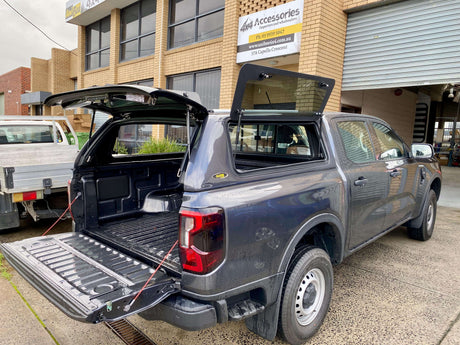 Truck with open tailgate showcasing Accessories 4x4 for off-road use