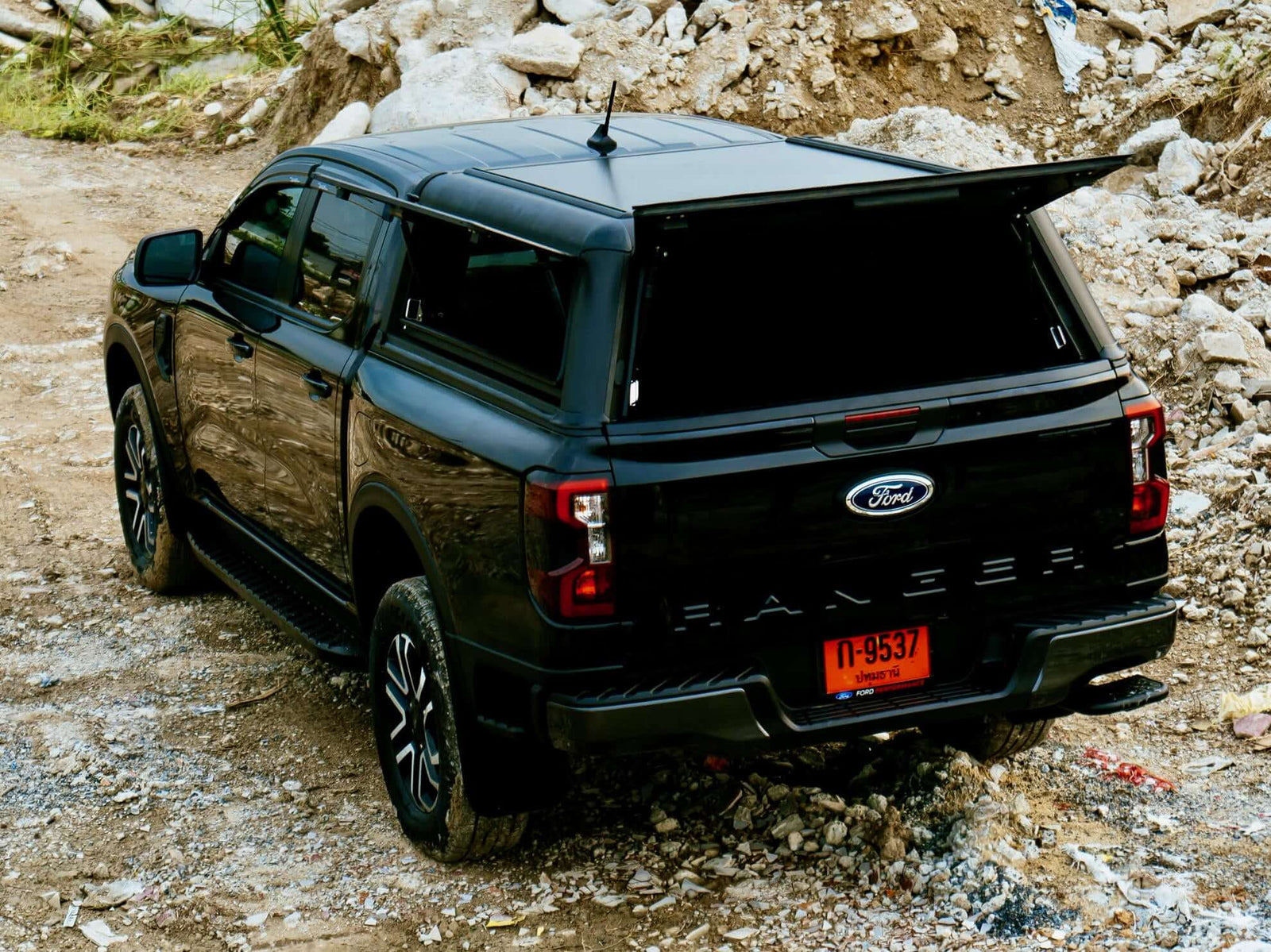 Black Ford Ranger NextGen Canopies on rugged terrain, showcasing utility and style in off-road settings.