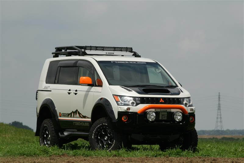 Delica D5 lift kit for enhanced off-road capability on grassy terrain.